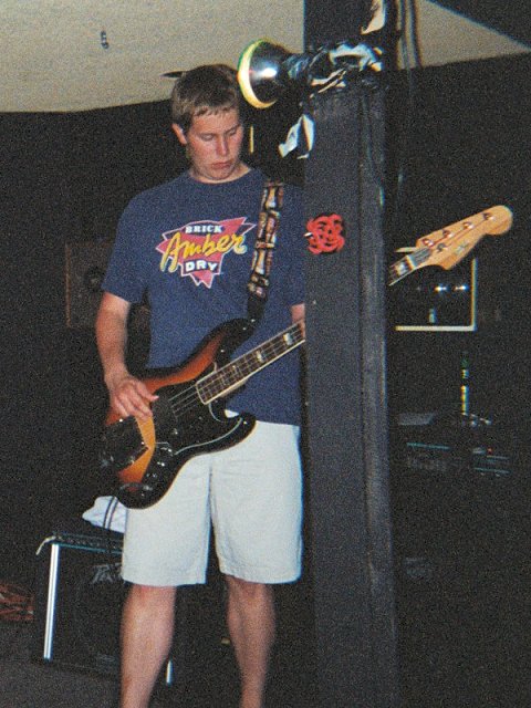 A picture of Rob Sample playing his bass guitar at The Underground