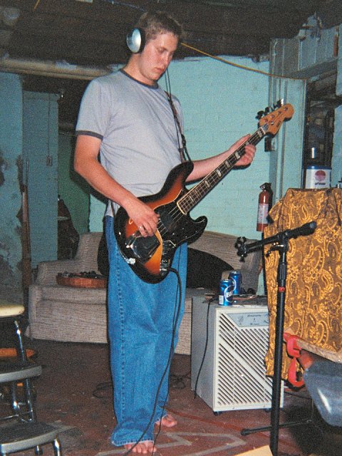 A picture of Rob Sample recording a bass guitar track